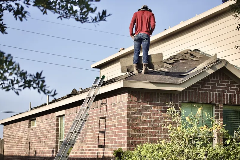 Professional roofer working on a residential roof in Sugar Land